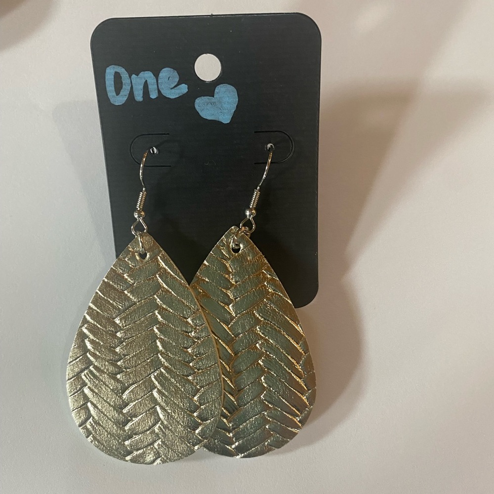 Gold colored earrings.